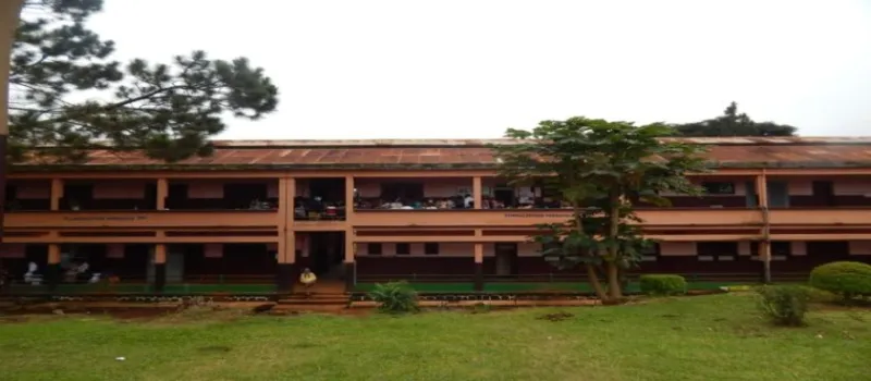 The long, two-storey Dschang District Hospital building behind a lawn
