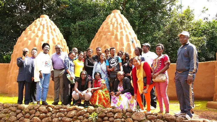The mission team gathered in front of traditional round huts