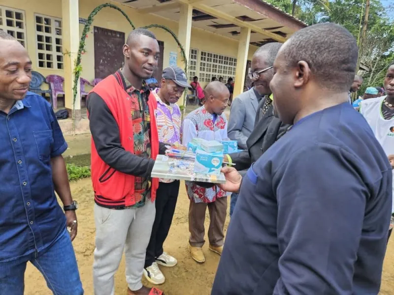Community members of CODENE presenting supplies