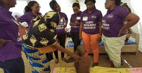 Volunteers attending to a mother and child
