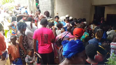 A dense crowd of displaced families waiting at the clinic