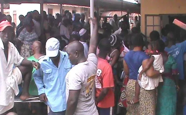 A crowd of patients and families waiting at a clinic in Bo