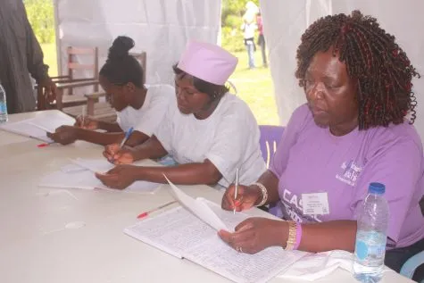 Volunteers registering patients at a table